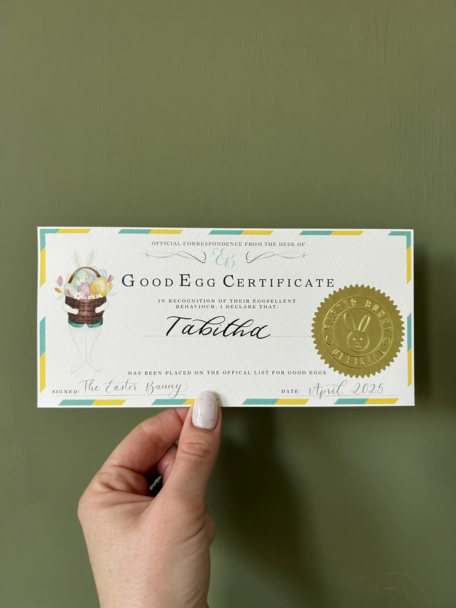 Letter and 'Good Egg' official certificate from the Easter Bunny Rabbit with bunny Easter basket illustration, calligraphy and golden embossed stamp with blue and yellow border