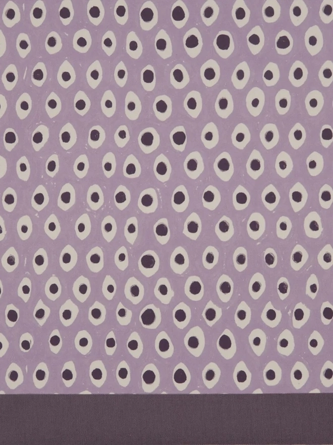 Paper Empire Lampshade. Close-up of a hand block printed lampshade showing a bold repeating geometric pattern. The colourful printed design and neat trim bring character and a handcrafted finish to any lamp.