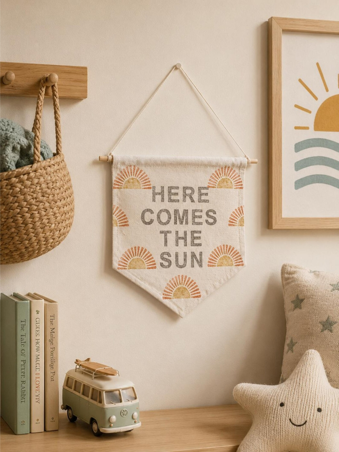 customised kids' bedroom cotton wall hanging. a banner with printed suns hanging on a bedroom wall.