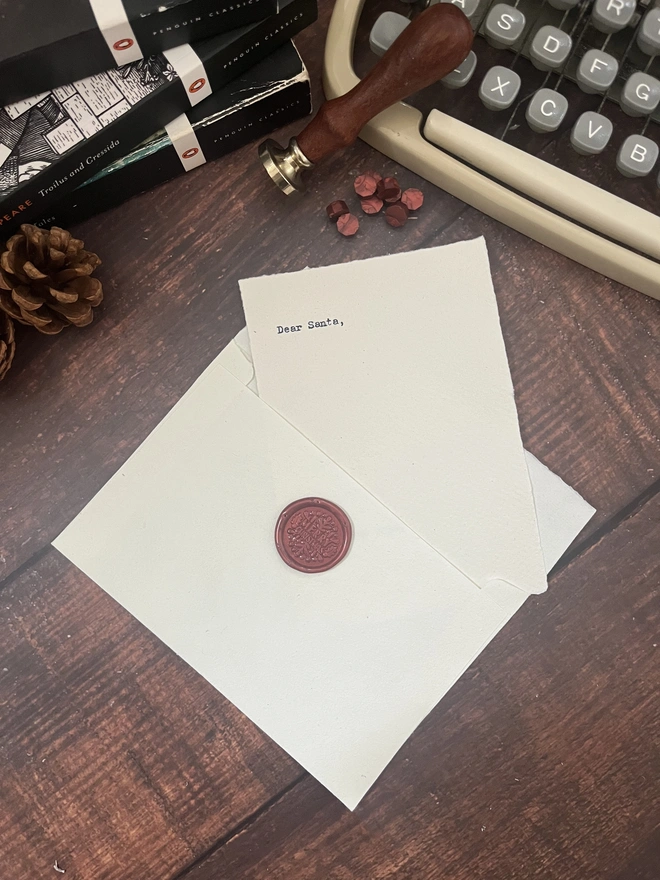 letter to santa, hand typed onto handmade cotton rag paper using an antique typewriter with a merry christmas red wax seal and envelope. 