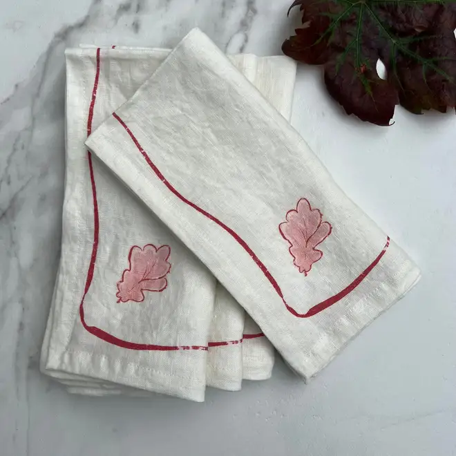 Oak Leaf Napkins (Set of 4). Light cloth napkin, folded on a marble table. 