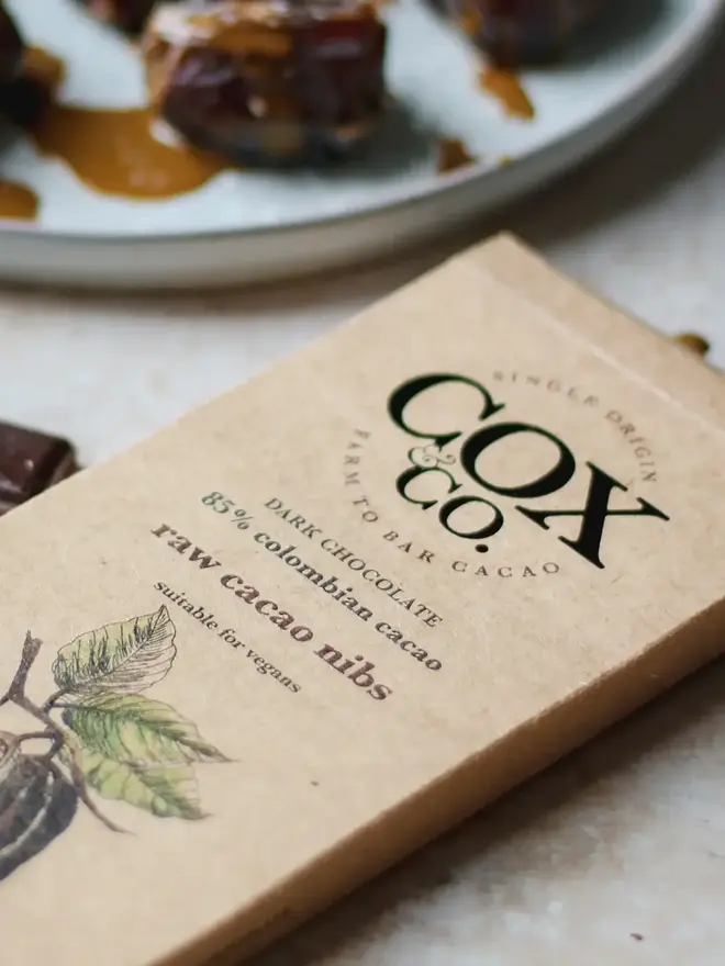 85% Raw Cacao Nibs Chocolate Bar (Set Of 1, 2 Or 3), a chocolate bar sitting on a table surface. 