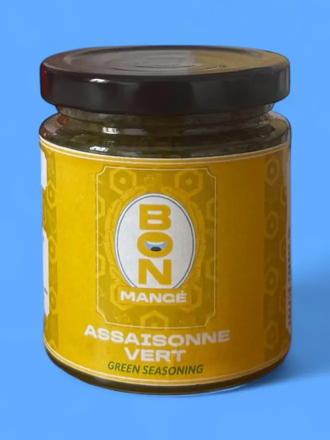Bon Mange Green Seasoning in a jar against a blue background