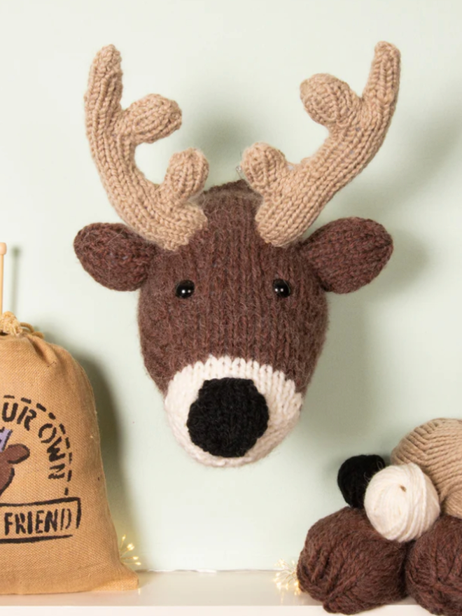 Deer Head Knit Kit. A giant deer head with black nose, mounted and completed.