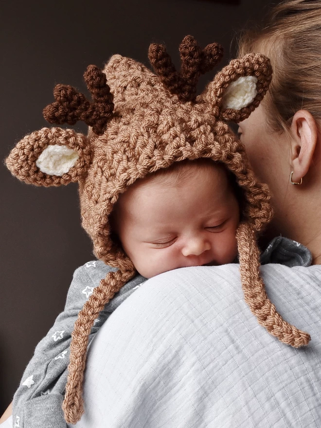 Newborn baby wearing deer hat