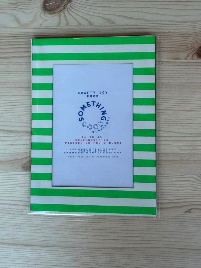 Thin Striped Screen Printed A6 / A5 / A4 Photo Mount. green striped mount pictured on a wooden table.