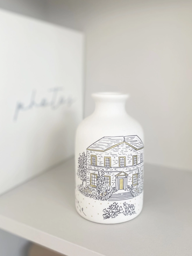 Ceramic vase on a bookshelf with a hand drawn black venue illustration