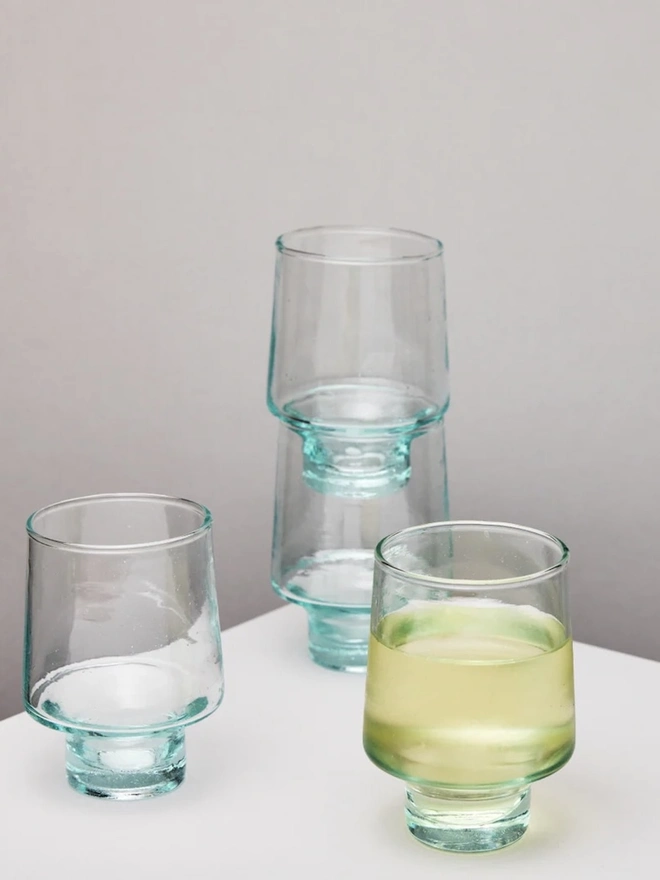 Tall Wine Glasses (Set Of 1 Or 4), a group of tall wine glasses sitting on a white counter top against a plain backdrop. 