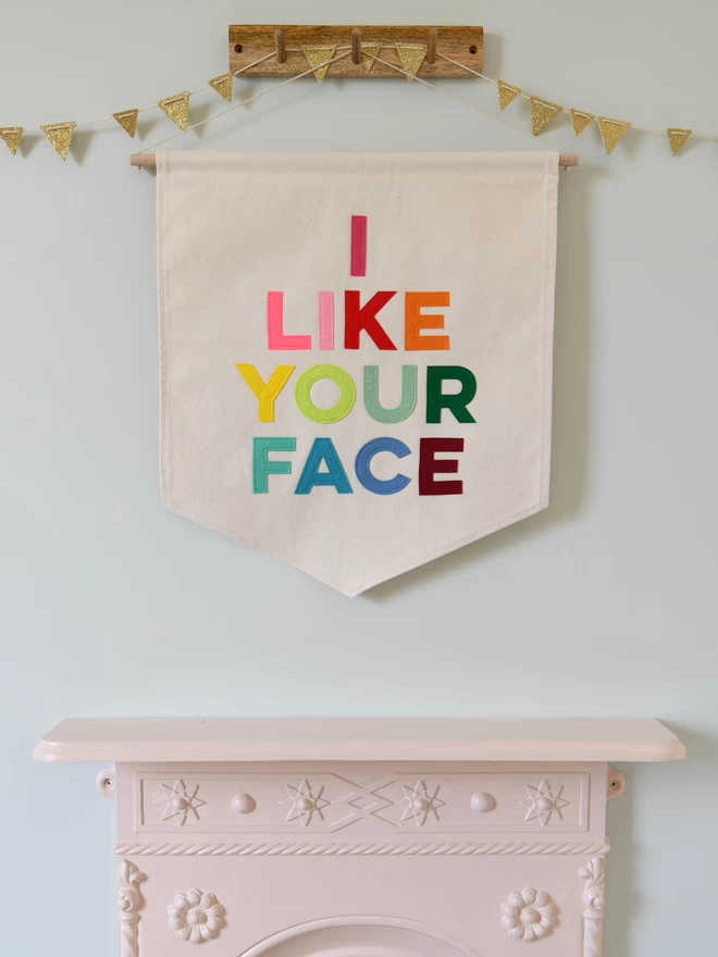 I like your face fabric wall hanging.