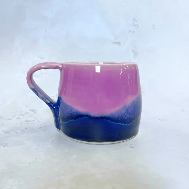 Landscape Large Round Mug, a colourful coffee mug on a stone surface. 