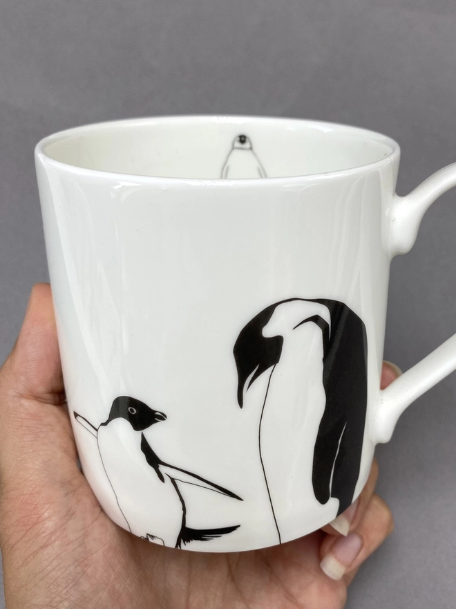 Close up of the black and white Emperor and Adelie penguins on the beautiful penguin mug