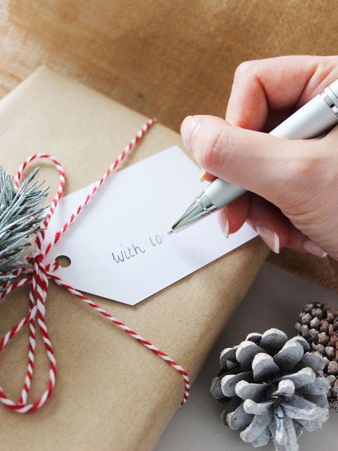 Christmas tag being written on