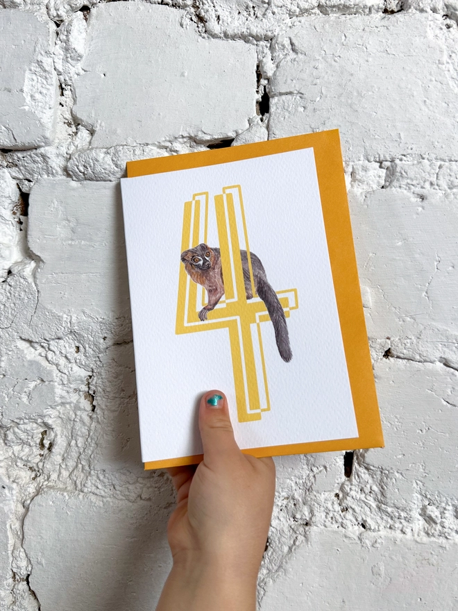 a white card with a big yellow 4 and a lemur illustration with a bright yellow envelope