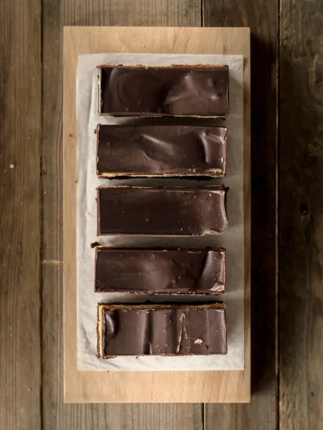 A tray of sliced billionaires brownies 