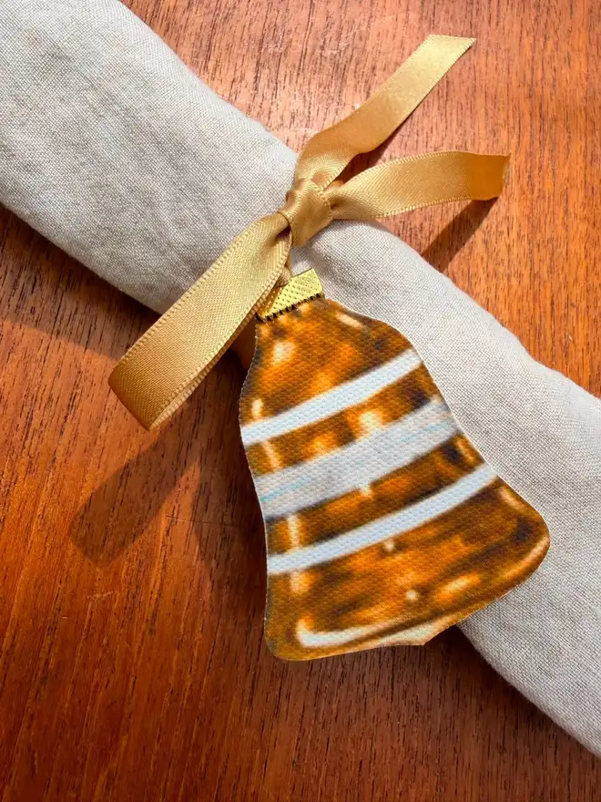 A vintage bauble shaped napkin tie with gold ribbon