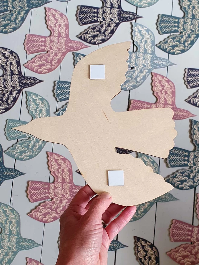 The reverse of a wall mounted blackbird decoration showing the adhesive wall stickers.