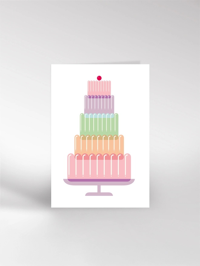 Birthday card featuring an illustration of a giant layered jelly on a stand with cherry on top