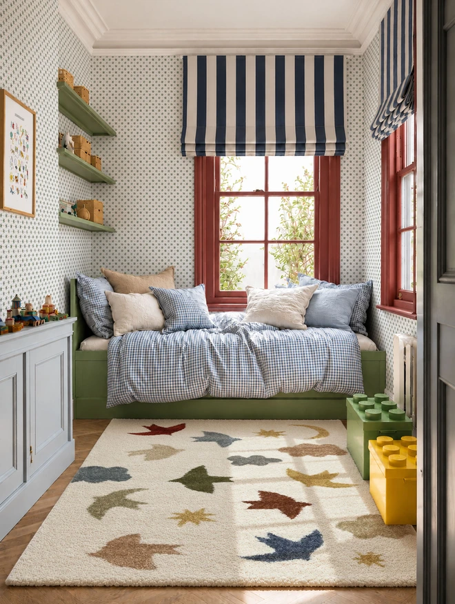 Ducks In A Row Stars and Spots Puddle Wallpaper in Boys Bedroom with patterned rug, colourful accessories, lego boxes