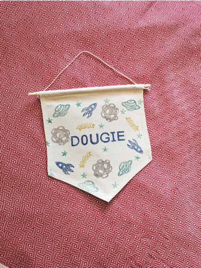 personalised space cotton wall hanging. a cotton banner laid flat.