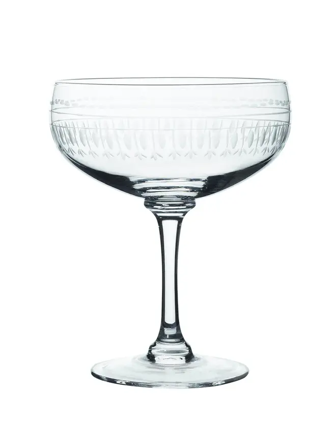 engraved oval crystal cocktail glasses. a cocktail glass with a detailed oval pattern.