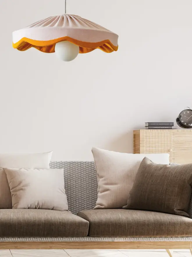 pink & mustard lampshade hanging above a couch