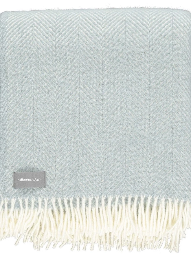 Organic Wool Throw, an organic wool throw folded on a white surface. 
