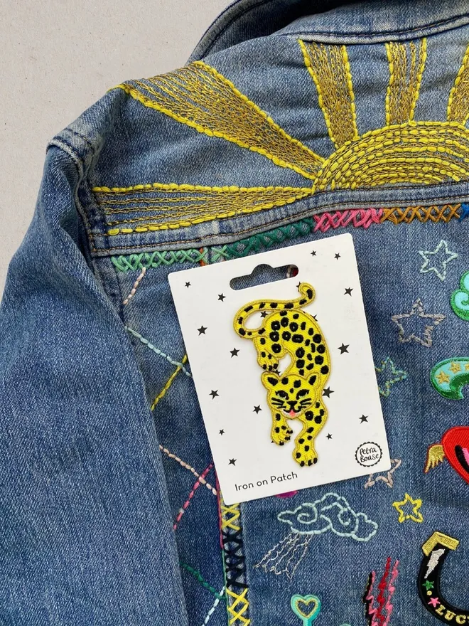 Leopard iron on patch on a denim jacket.