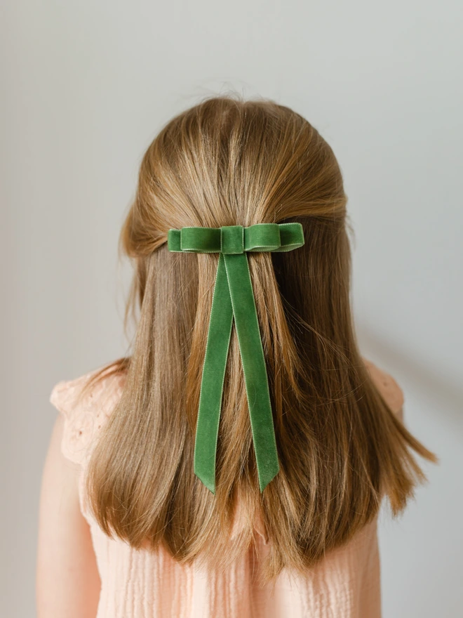 girl wearing her green velvet hair bow