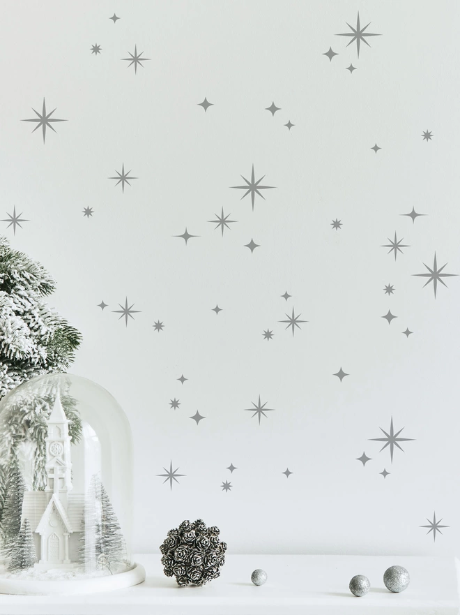 twinkly stars wall sticker set in light grey on a white wall