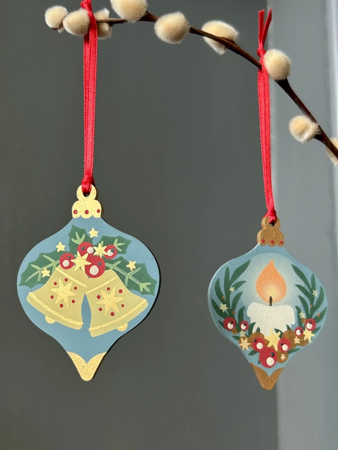 Laser cut wooden bauble shapes which have been hand painted with one christmas candle design and one with a festive bell design. Using blue, yellow, green, red and gold paint.