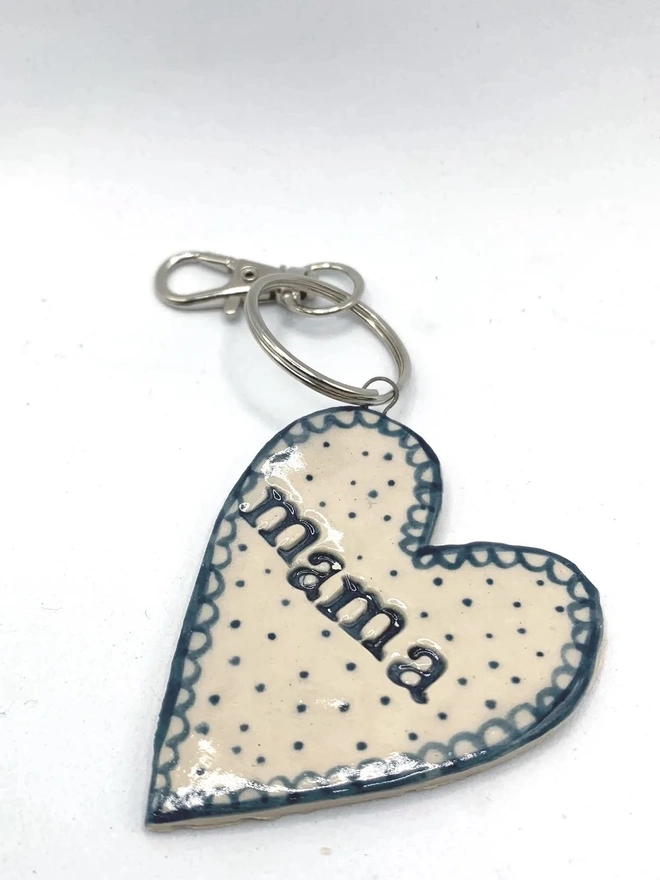 Mama Heart Ceramic Keyring, a blue keyring sitting on a plain white surface. 