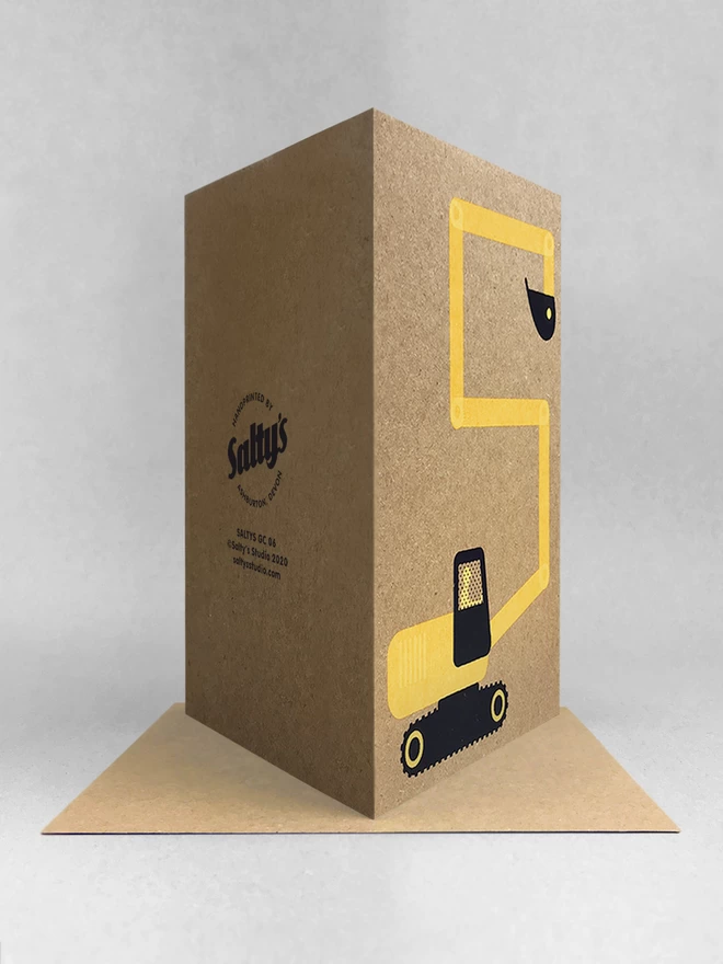 Rear view of a yellow and black digger, its arm makes a number 5, screenprinted on a Kraft brown card. Stood on a Kraft envelope, with white background with a light grey shadow
