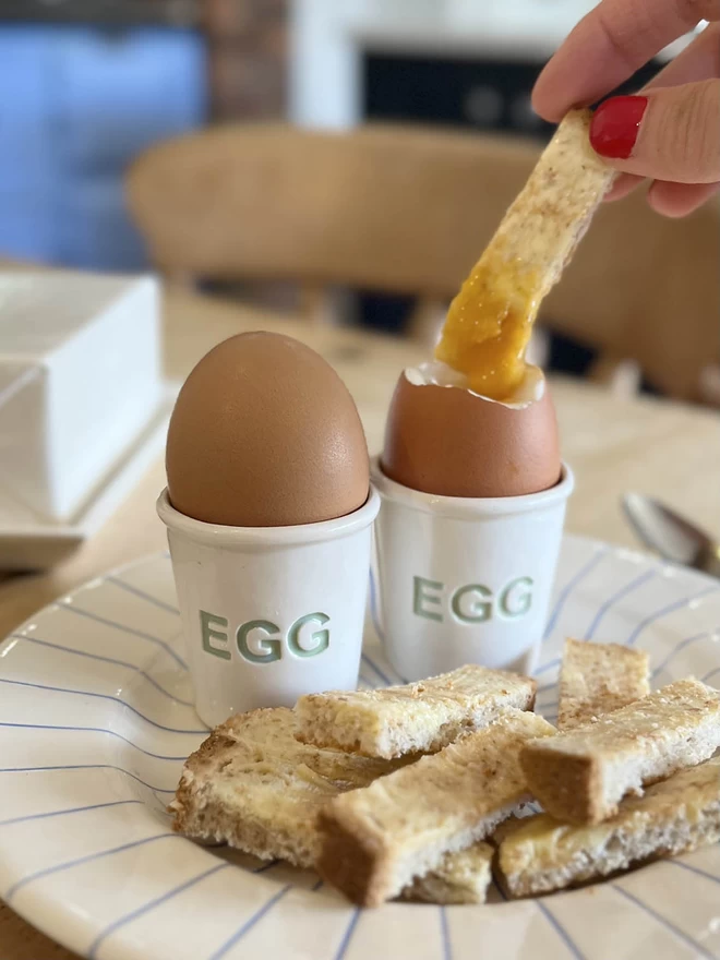 When one is not enough, two handmade ceramic egg cups hold boiled eggs ready for toasted solders.