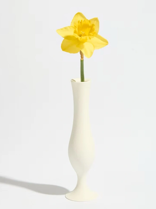 flute shaped white 3d printed vase with yellow flower