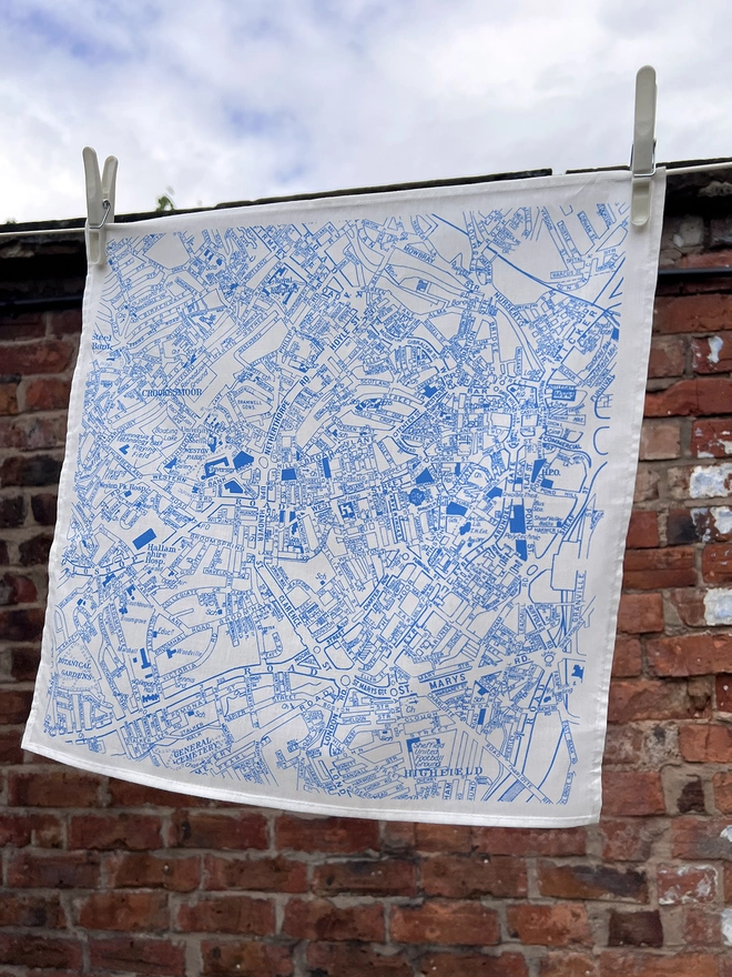A Mr.PS Sheffield Handkerchief pegged on a washing line in front of a brick wall