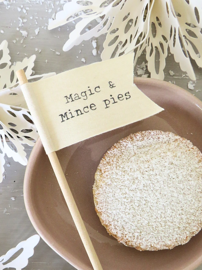 Organic cotton flag hand painted with festive message wrapped around wooden dowel