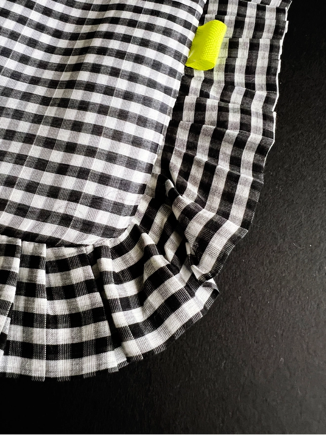 Close up of black and white gingham cloth tote bag ruffled edge