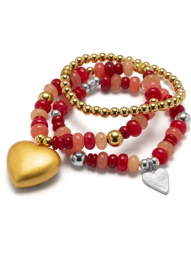 vibrant red and soft pink jade beads for a joyful pop of colour. Finished with a charm of your choice, this stretch bracelet is made to lift your mood and your look. 