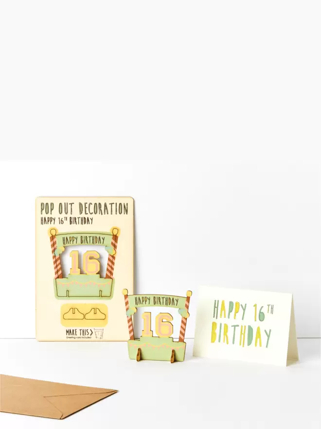 Sixteenth birthday decoration and sixteenth birthday card and brown kraft envelope on a white background