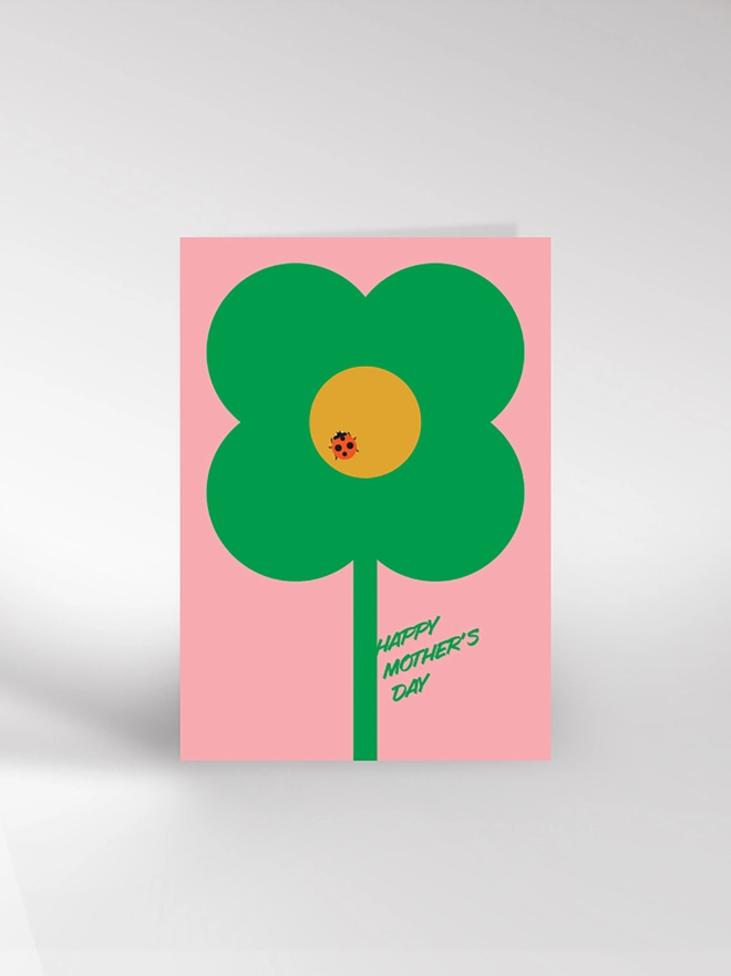Contempopary Mother's Day card with an illustration of a single flower with ladybird