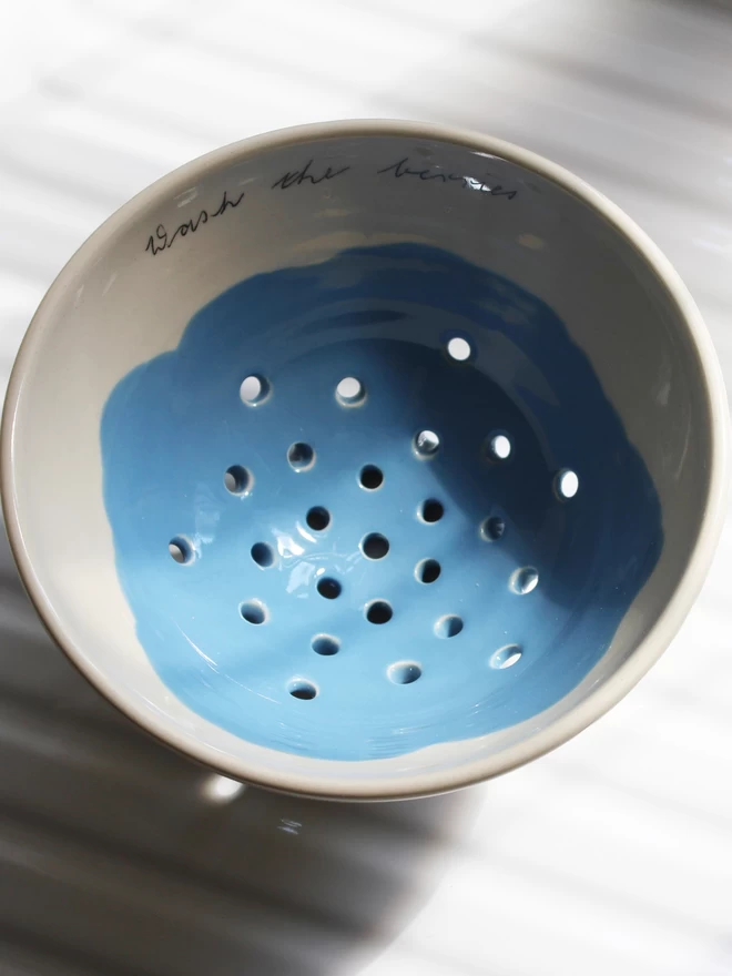 berry bowl on draining board on kitchen sink