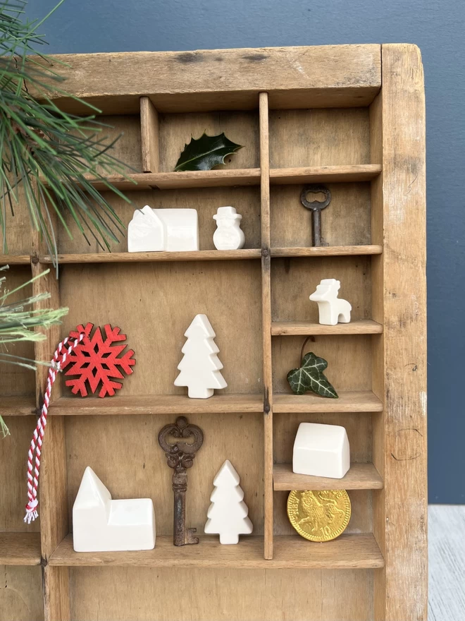 Handmade ceramic Mini Christmas Village in an old wooden print try with other tiny treasures. 