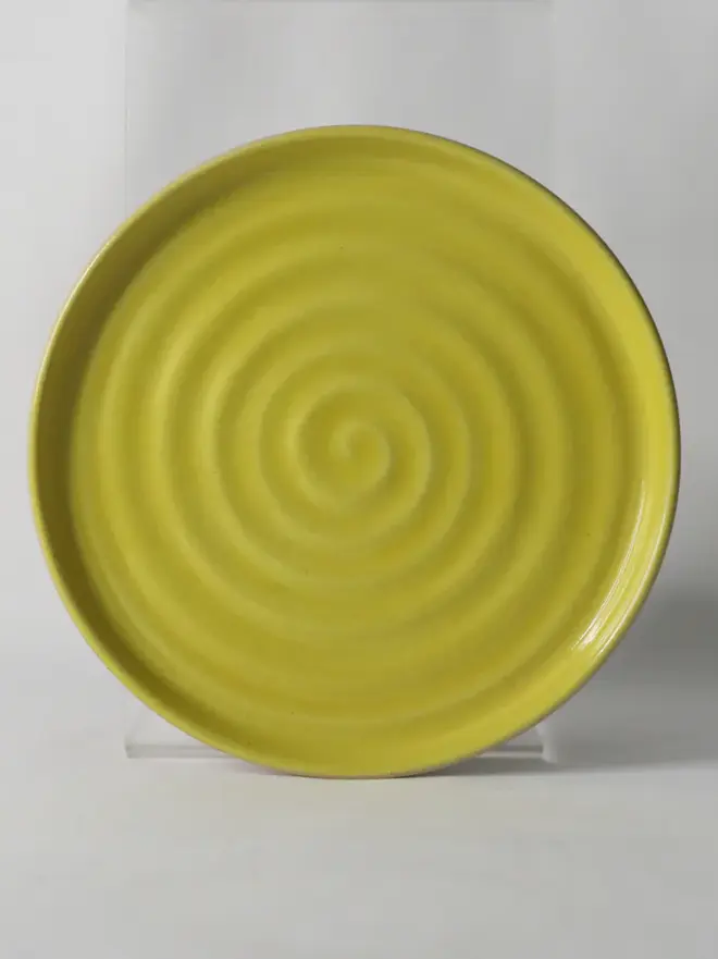 yellow ceramic cake plate with textured swirl design