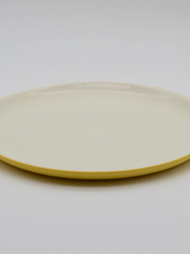 Dinner Plate. A yellow dinner plate.