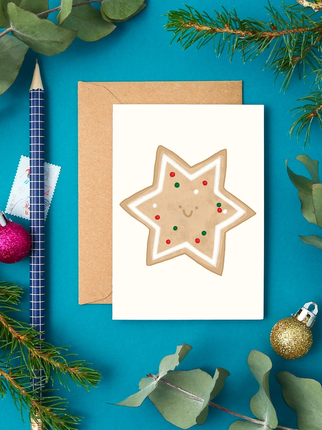 Mini Christmas card with illustration of a star-shaped cookie with icing and red and green sprinkles
