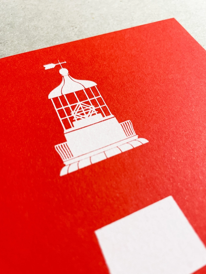 Close up of the light detail at the top of the iconic tower on Plymouth Hoe, Smeaton's Tower. It is screenprinted in white only on a red card, showcasing the stripes and details at the top. Its title is written at the base. The card is laid in a light grey studio background.