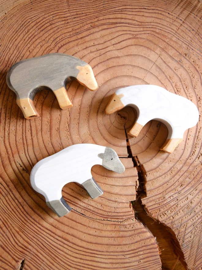 wooden toy sheep on wood slice