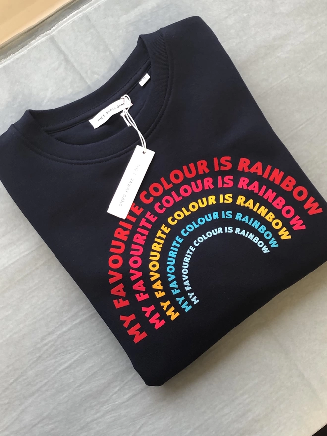 a 'Rainbow' Sweatshirt by The Faraway Gang with a rainbow on it in navy..