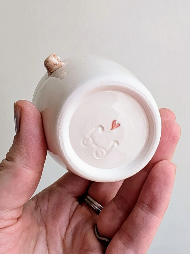 white ceramic espresso cup showing the red heart on the base of the mugi