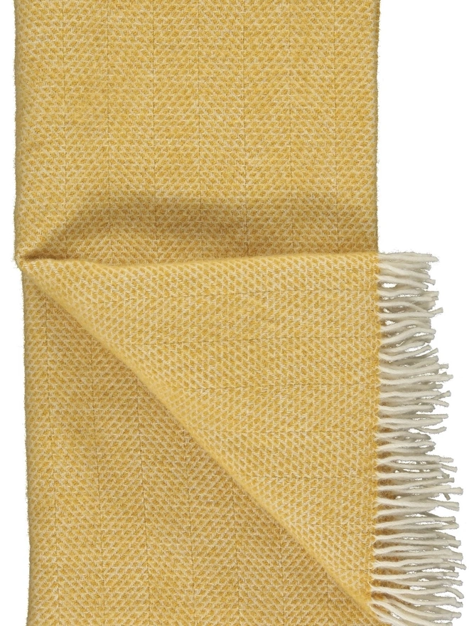 Organic Wool Throw, an organic wool throw folded on a white surface. 
